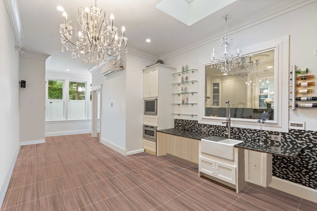 50 Baldwin Street Boston, MA 02129 - Photo 10 of 24 a spacious bathroom with a granite countertop sink a large mirror and shower