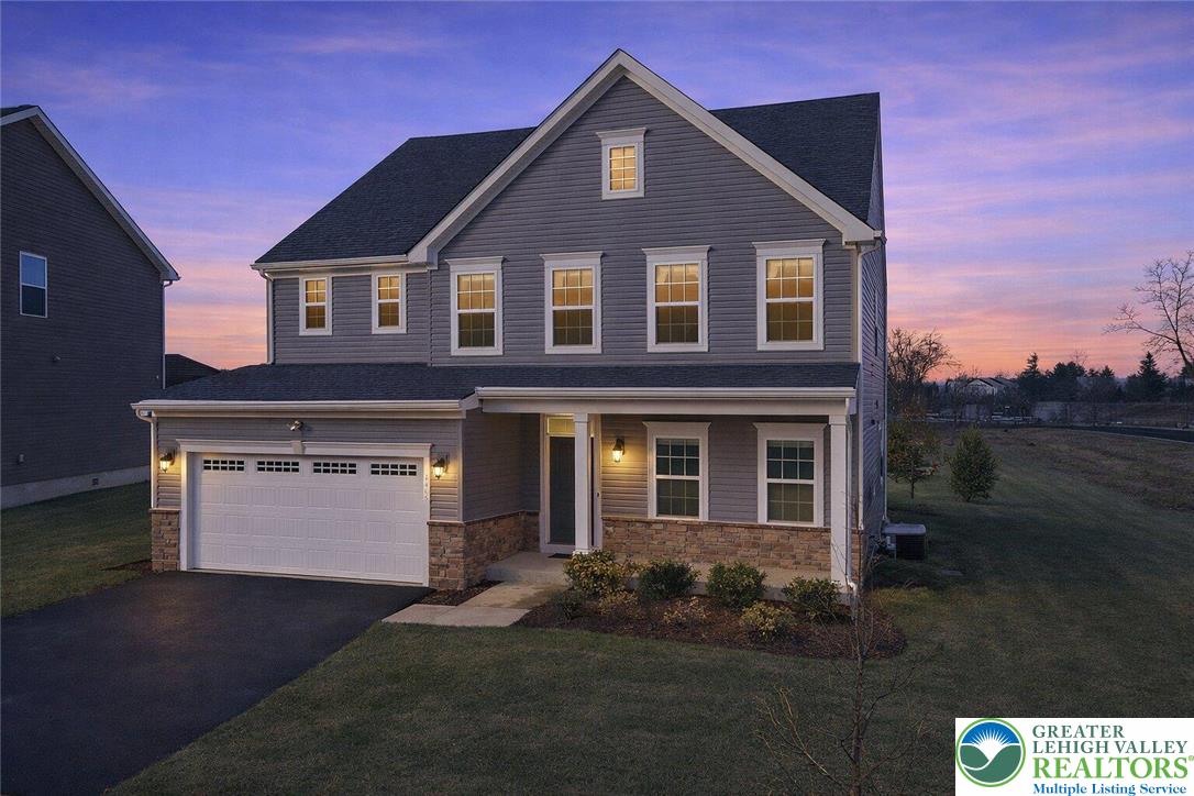 a front view of a house with a yard and garage