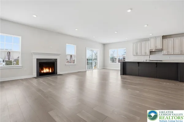 a kitchen with stainless steel appliances sink a stove and white cabinets