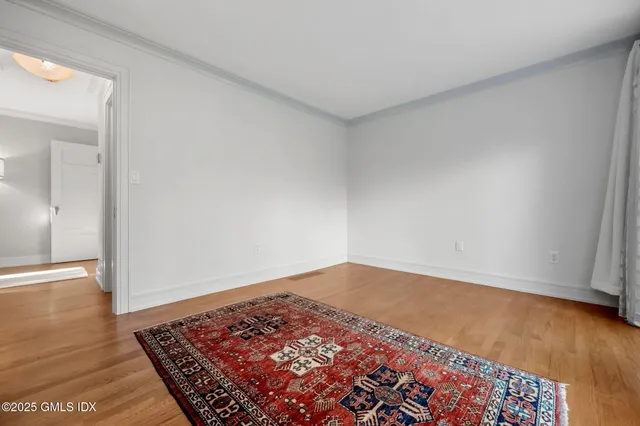 an empty room with wooden floor