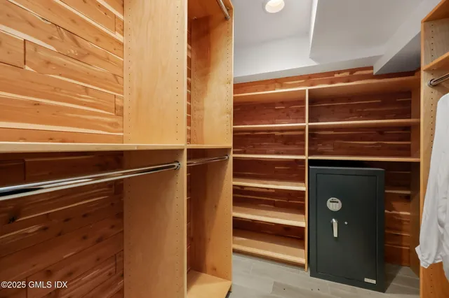 a view of walk in closet with empty racks