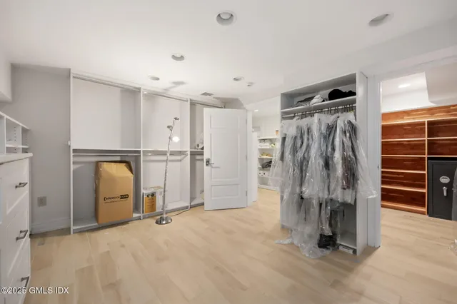 a view of walk in closet with clothes