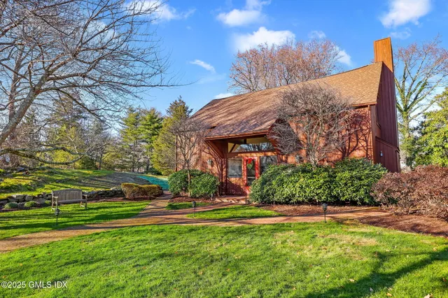 a view of a yard with plants and trees
