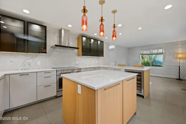 a kitchen with a sink a counter space and stainless steel appliances