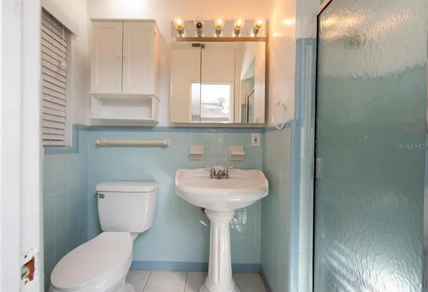 a bathroom with a sink a mirror and a toilet