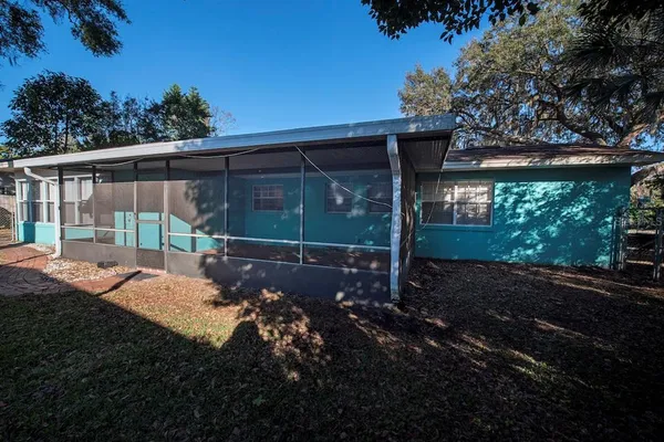 a view of a house with backyard and sitting area
