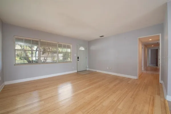 wooden floor in an empty room with a window