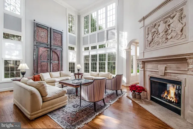 a living room with furniture a fireplace and a large window