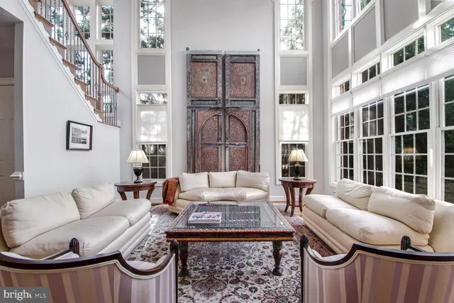 a living room with fireplace furniture and a large window