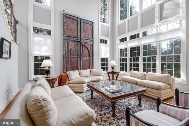 a living room with furniture a fireplace and a large window