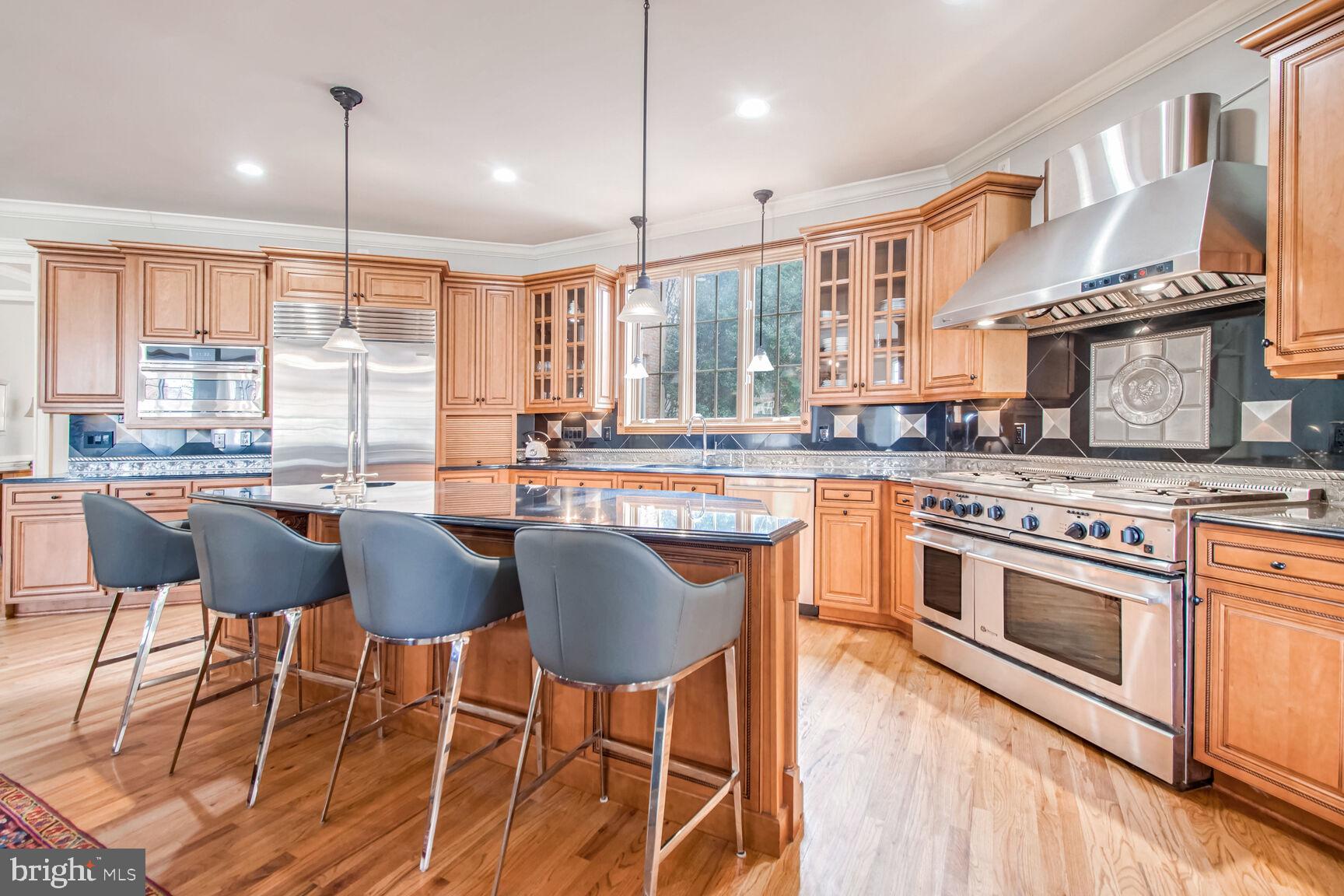 1550 Shelford Court Vienna, VA 22182 - Photo 24 of 60 a kitchen with stainless steel appliances granite countertop a stove a sink dishwasher and a refrigerator with wooden floor