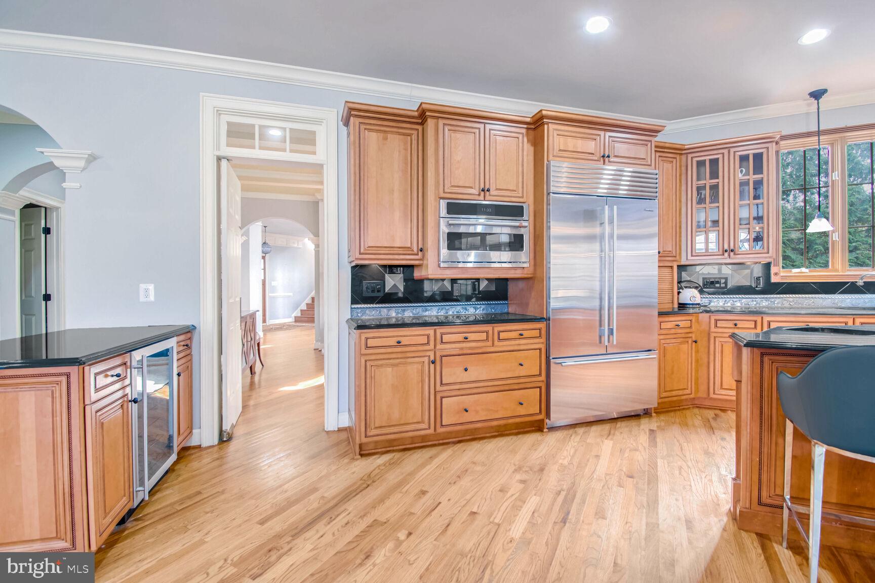 1550 Shelford Court Vienna, VA 22182 - Photo 25 of 60 a kitchen with stainless steel appliances kitchen island granite countertop a stove and a wooden cabinets