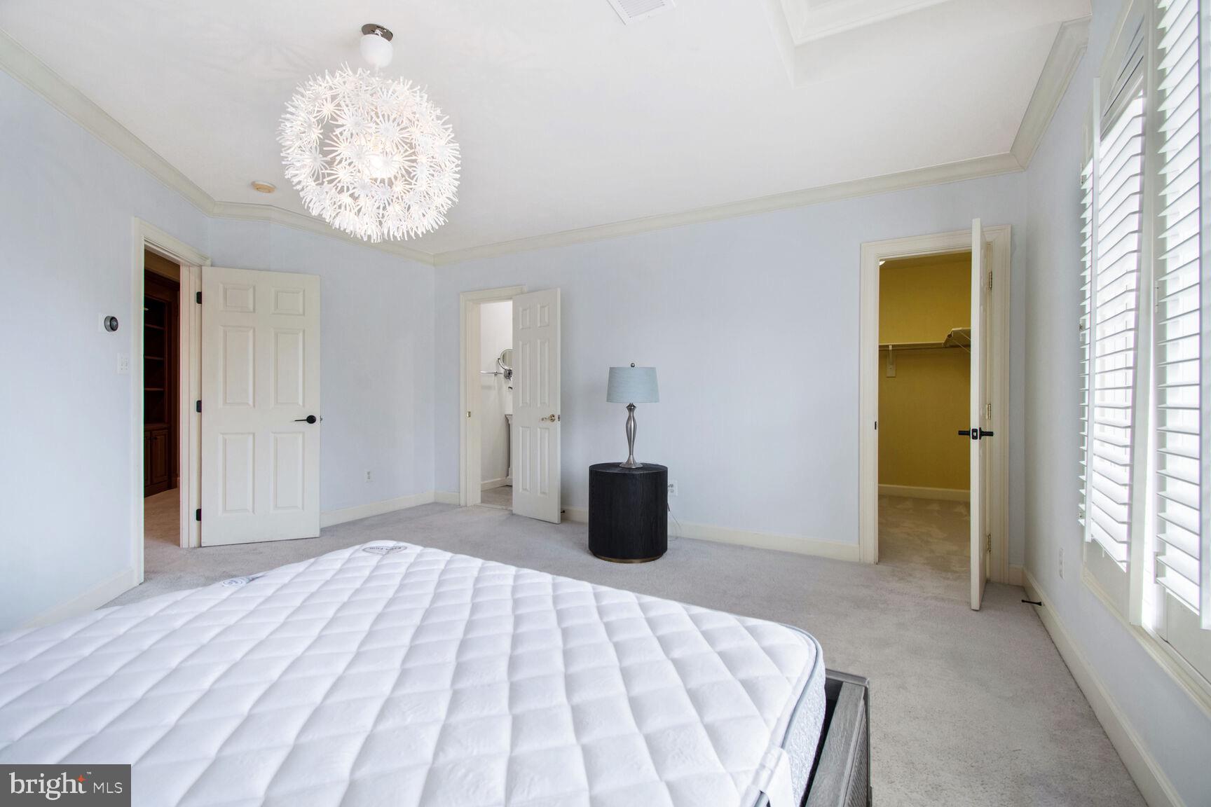 1550 Shelford Court Vienna, VA 22182 - Photo 31 of 60 a bedroom with a bed and a chandelier