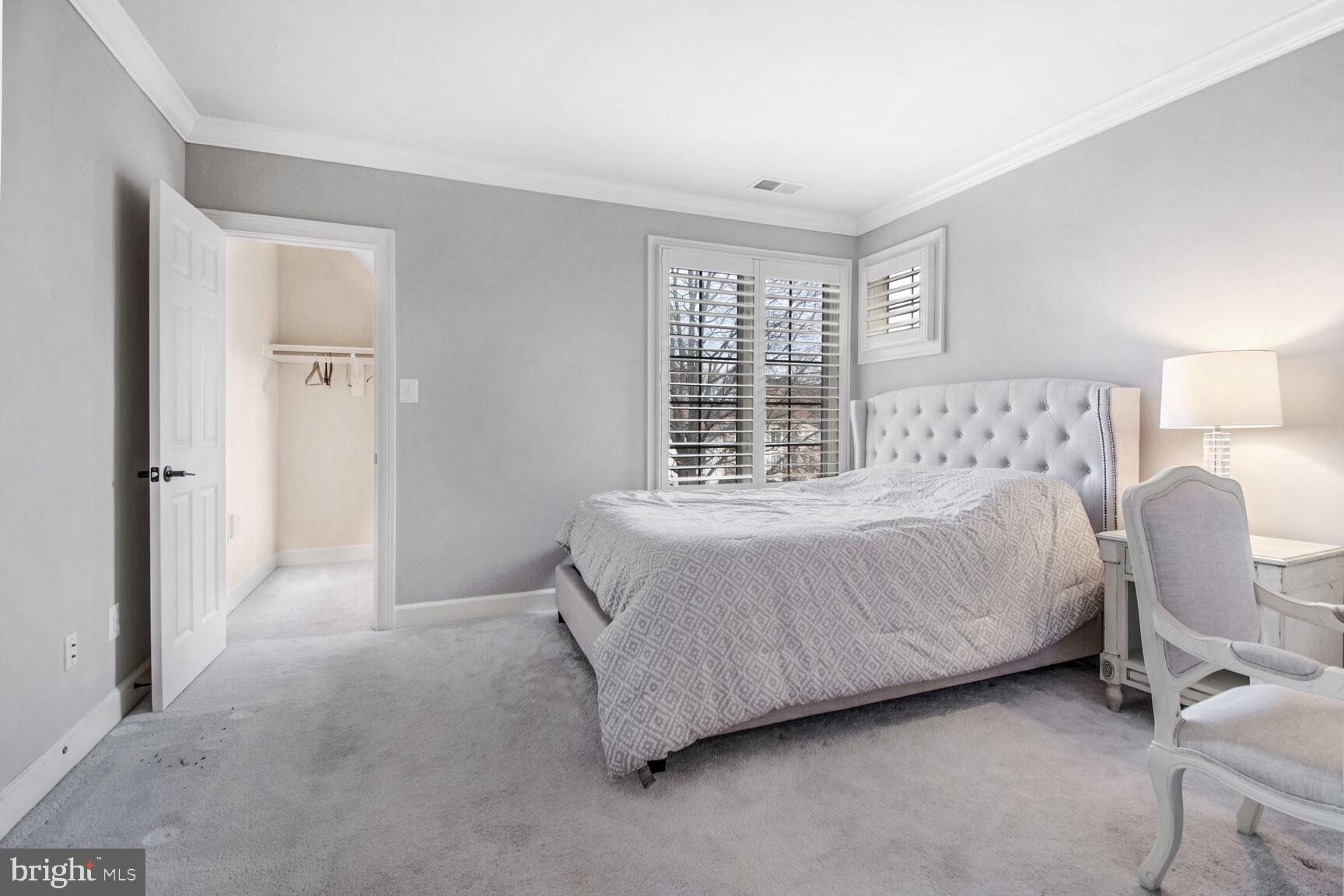 1550 Shelford Court Vienna, VA 22182 - Photo 32 of 60 a bed sitting in a bedroom next to a window