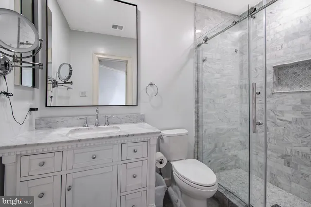 a view of a hallway with wooden floor and windows