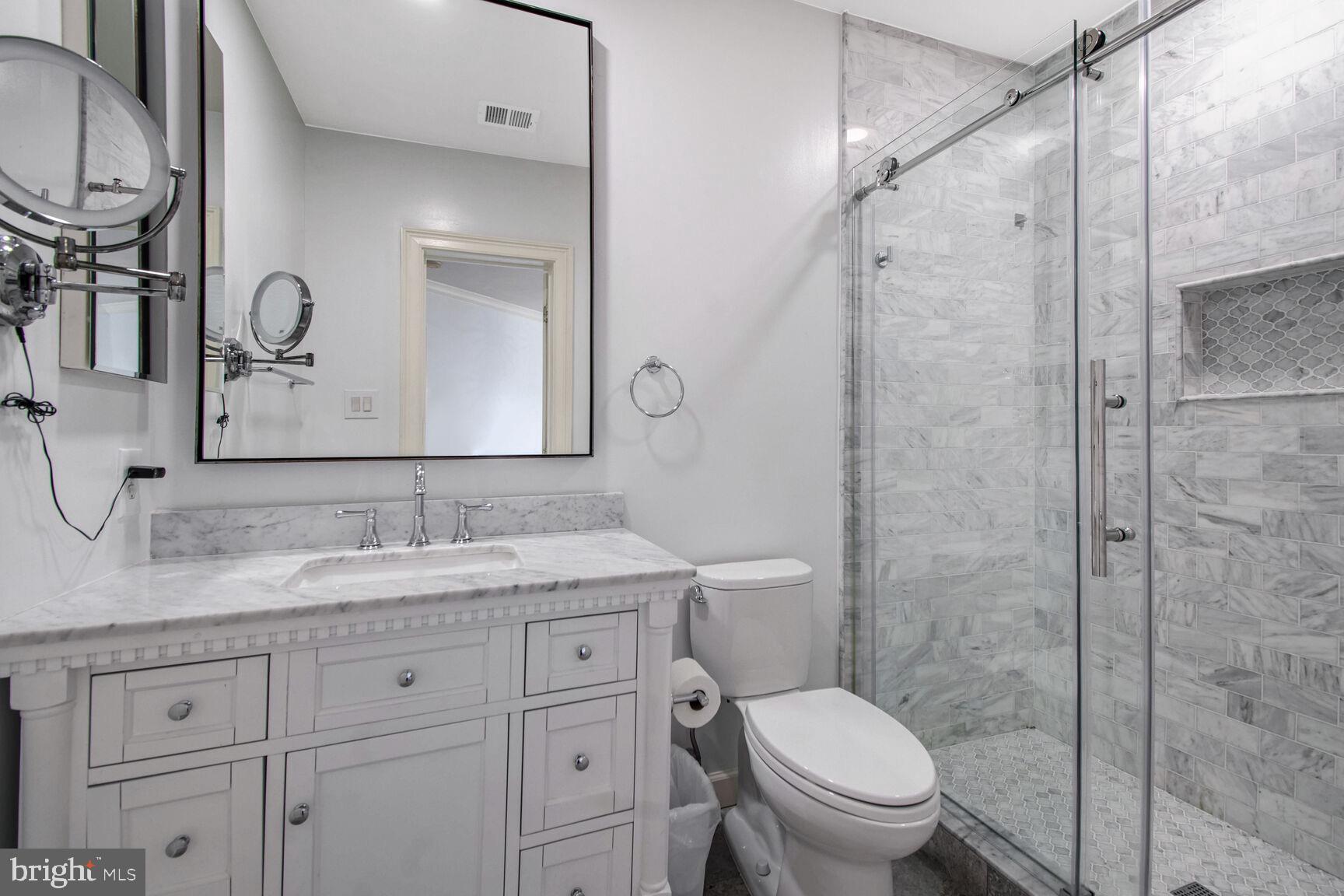 1550 Shelford Court Vienna, VA 22182 - Photo 37 of 60 a bathroom with a granite countertop sink toilet and shower