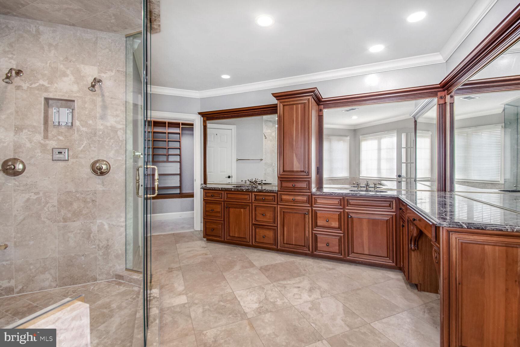 1550 Shelford Court Vienna, VA 22182 - Photo 38 of 60 a large bathroom with a granite countertop double vanity sink a mirror and a shower