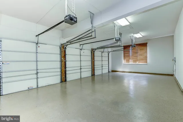 a view of a hallway with wooden floor and a chandelier