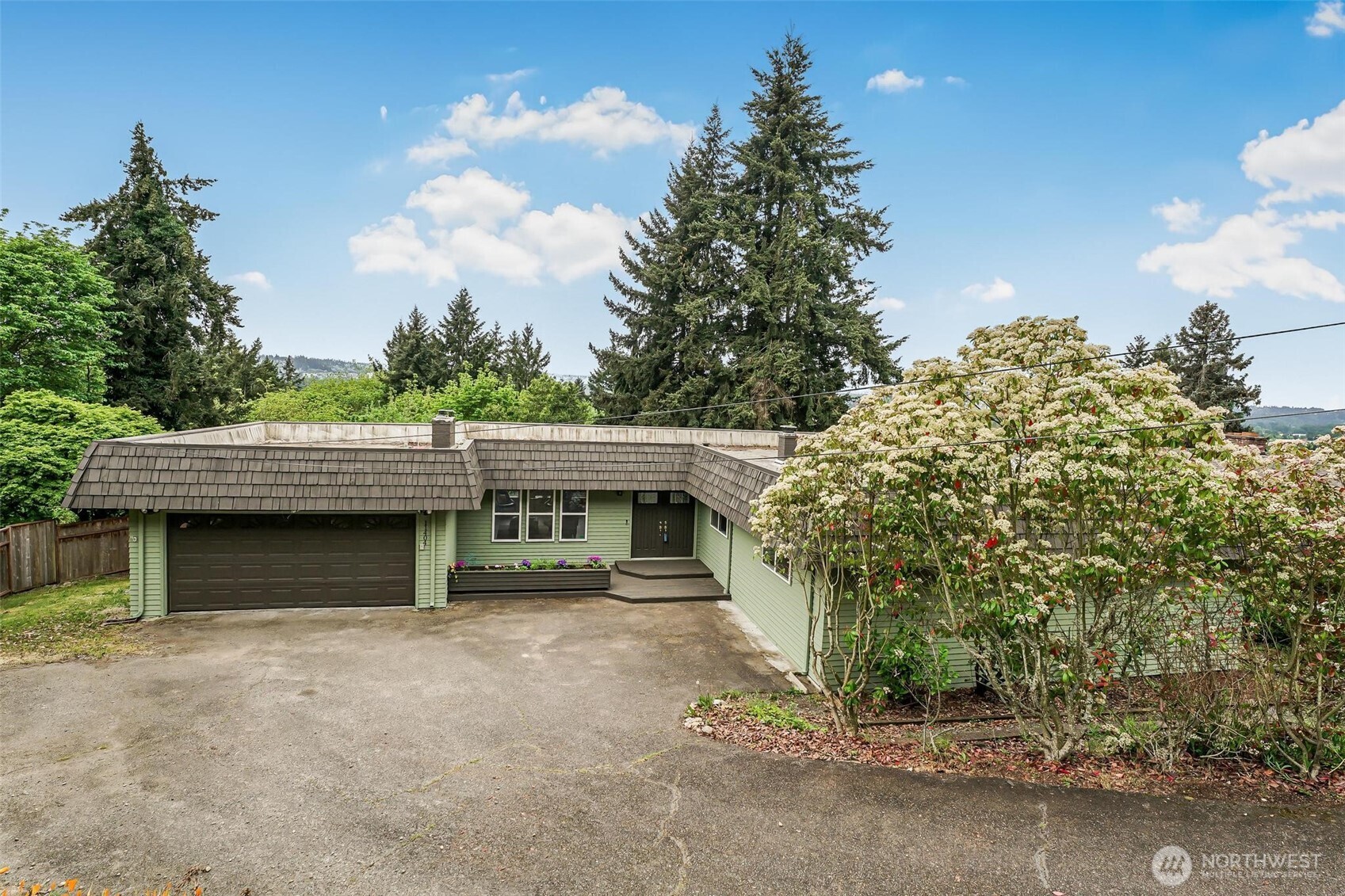 11404 Karshner Road East Edgewood, WA 98372 - Photo 3 of 40 a front view of a house with a garage