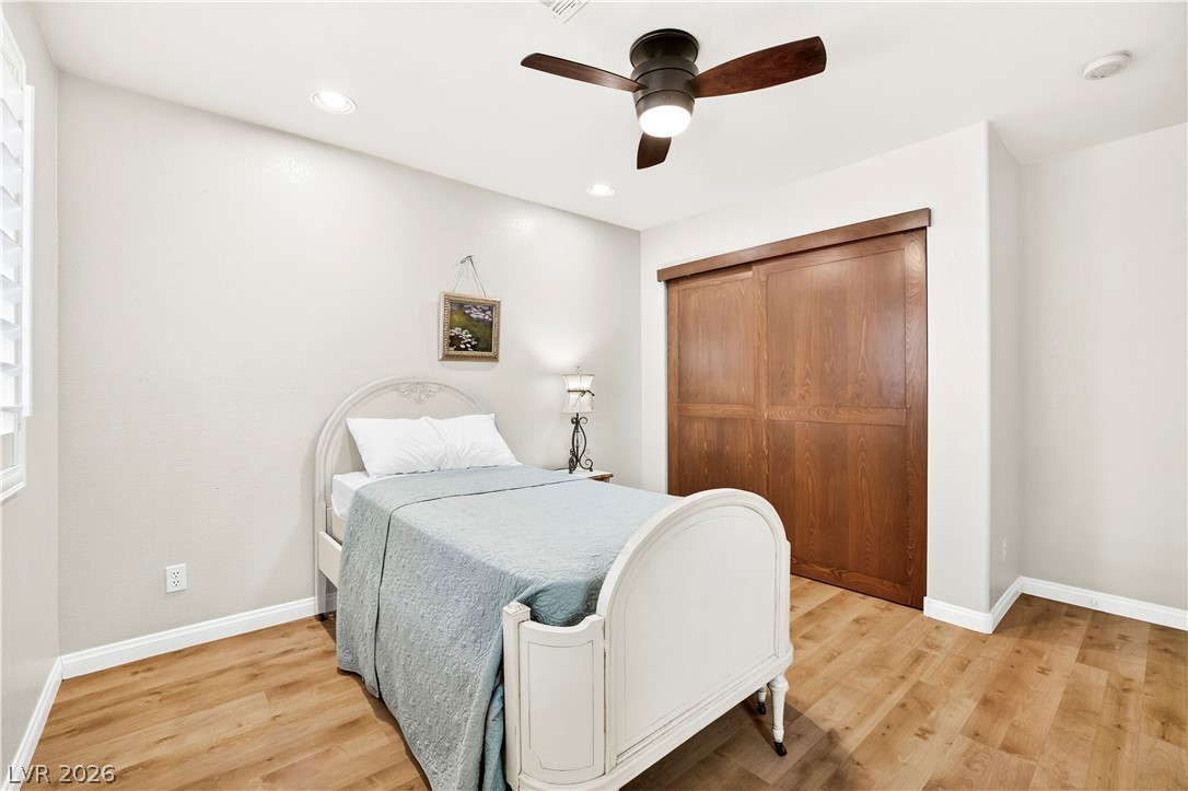 1135 Calico Ridge Drive Henderson, NV 89011 - Photo 42 of 86 Wood-look flooring and recessed lighting define this peaceful, naturally illuminated bedroom.