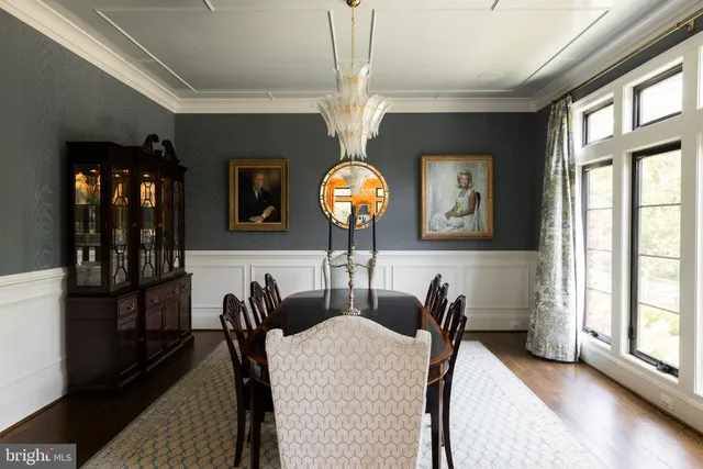 a view of a dining room with furniture and a chandelier