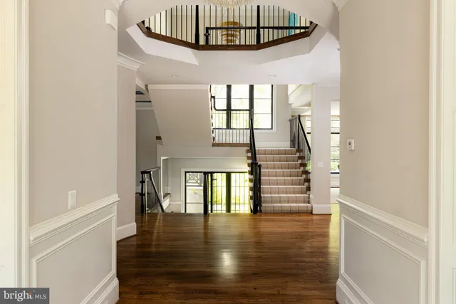 a view of entryway and hall with wooden floor