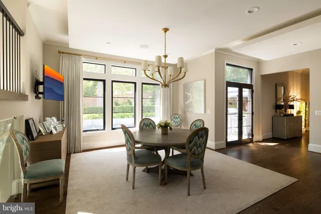 a large white kitchen with kitchen island a sink a stove and a refrigerator