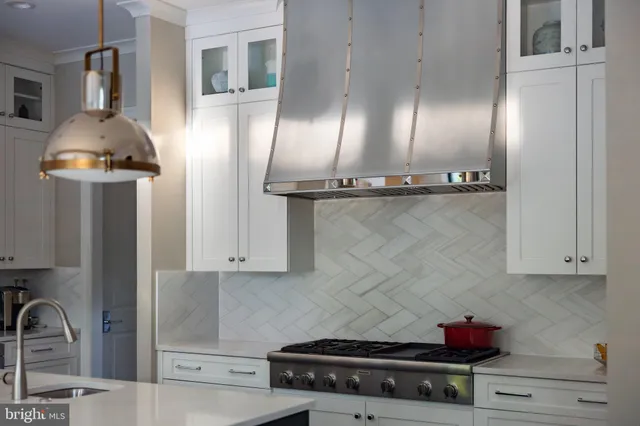 a kitchen with stainless steel appliances kitchen island granite countertop a refrigerator stove and sink