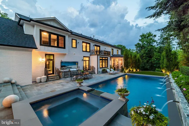 a view of a house with swimming pool and sitting area