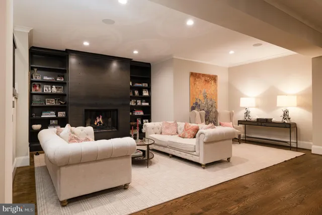 a living room with furniture a fireplace and a large window