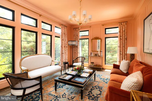 a living room with furniture and floor to ceiling windows