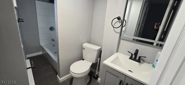a white toilet sitting next to a bathroom sink