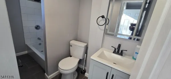 a white toilet sitting next to a bathroom sink