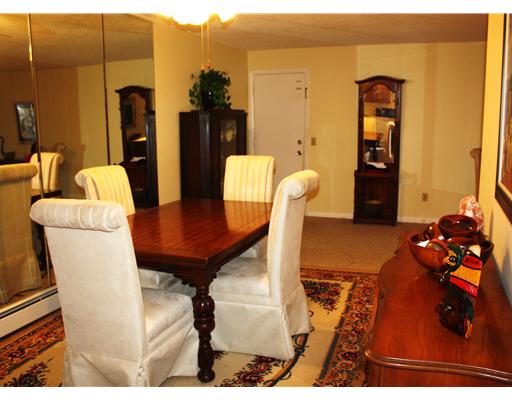 Dining Room. Standing in the kitchen looking through the dining room toward the front door. The dining area is large enough to accomodate a good sized table and chairs. The living room is to the right.