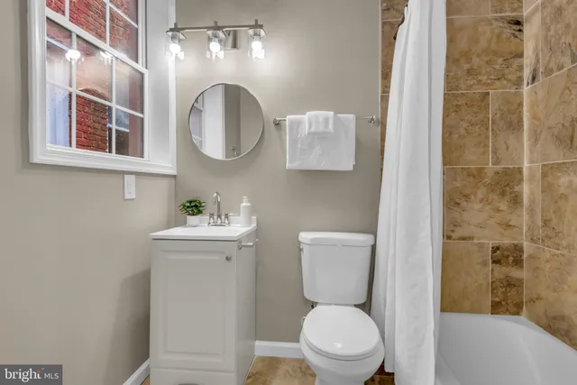 a white toilet sitting next to a bathroom sink