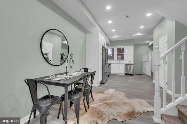 a view of a dining room with furniture and a mirror