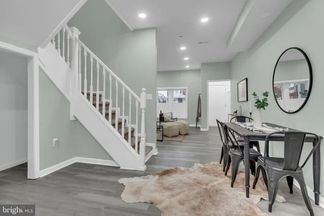 a view of a dining room with furniture and a mirror
