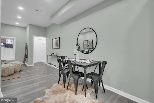 a view of a dining room with furniture and a mirror