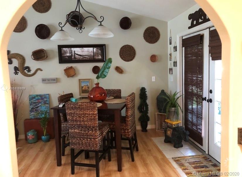 128 Kilpatrick Road Clewiston, FL 33440 - Photo 12 of 35 a dining room with furniture and a rug