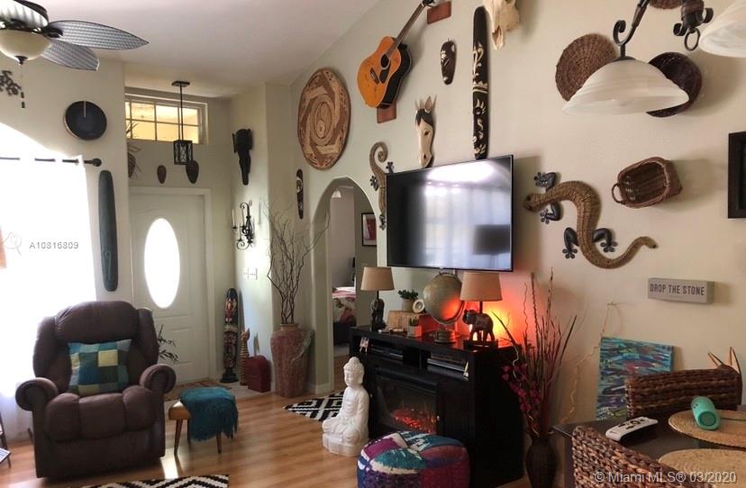 128 Kilpatrick Road Clewiston, FL 33440 - Photo 13 of 35 a living room with blue lights with furniture and a floor