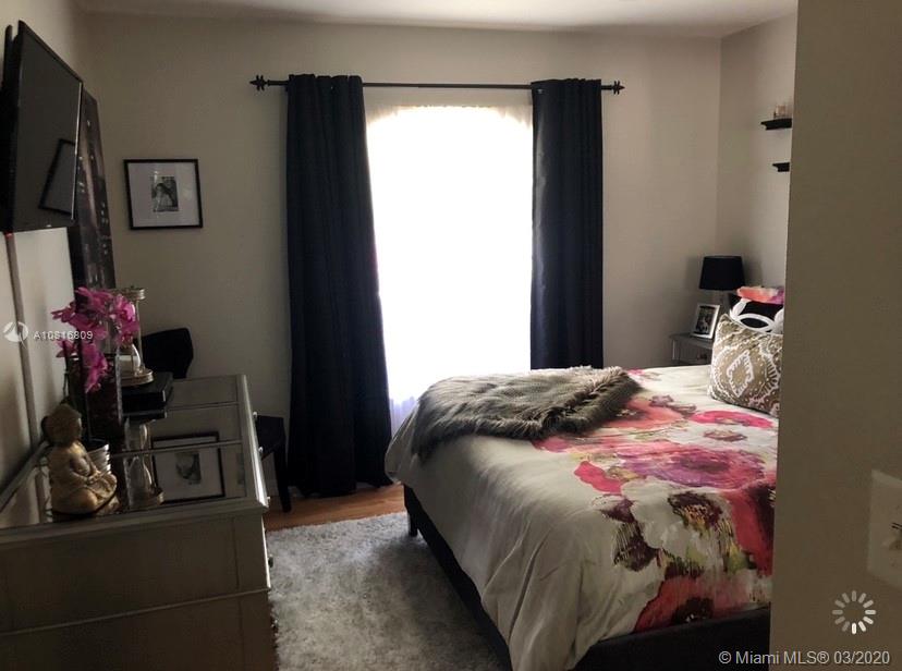 128 Kilpatrick Road Clewiston, FL 33440 - Photo 15 of 35 a bedroom with a bed and flat screen tv