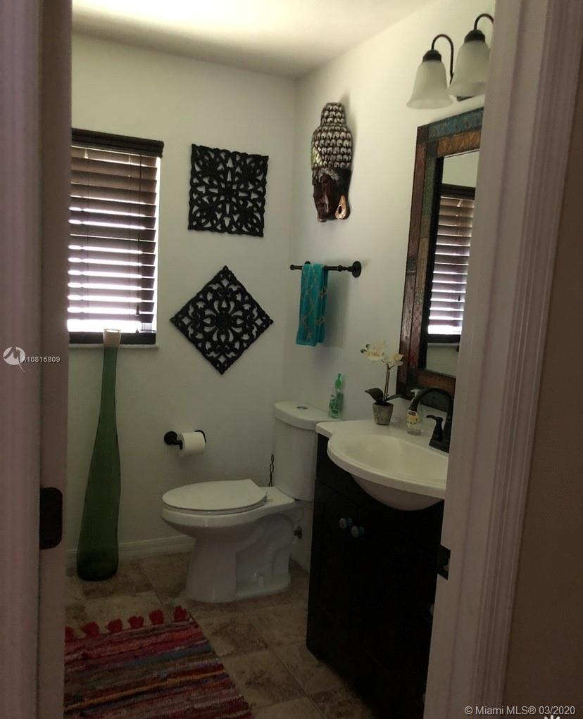 128 Kilpatrick Road Clewiston, FL 33440 - Photo 17 of 35 a bathroom with a sink toilet and mirror