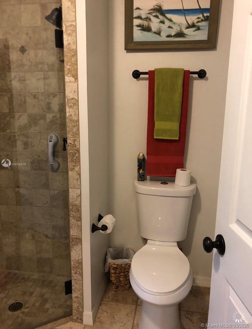 128 Kilpatrick Road Clewiston, FL 33440 - Photo 27 of 35 a white toilet sitting next to a bathroom sink