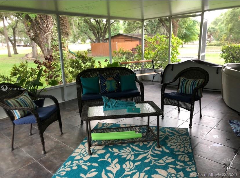 128 Kilpatrick Road Clewiston, FL 33440 - Photo 32 of 35 a view of two chairs sitting in a yard