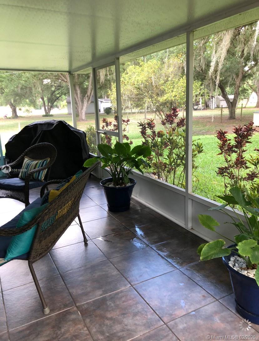 128 Kilpatrick Road Clewiston, FL 33440 - Photo 33 of 35 a living room with patio furniture and a potted plant