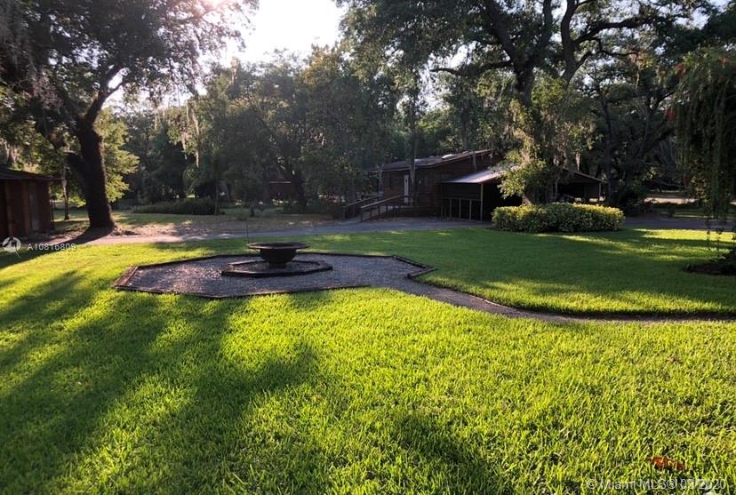 128 Kilpatrick Road Clewiston, FL 33440 - Photo 5 of 35 a swimming pool with outdoor seating and yard
