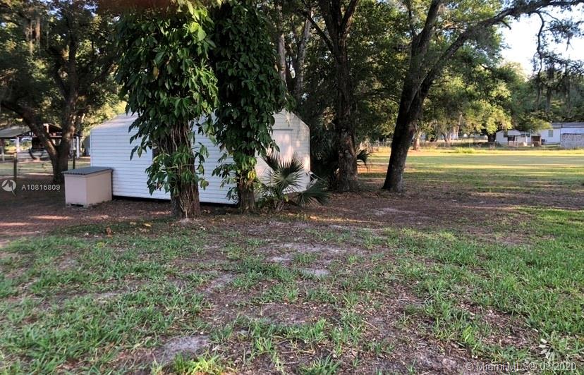 128 Kilpatrick Road Clewiston, FL 33440 - Photo 7 of 35 a view of a tree in front of a house