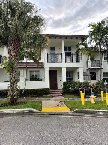 a view of a house with swimming pool and a yard in front of the house