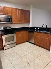a kitchen with stainless steel appliances granite countertop a sink and a stove