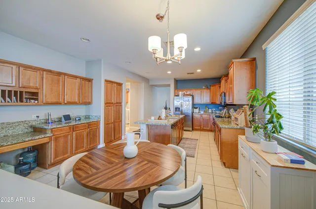 a large kitchen with a table and chairs